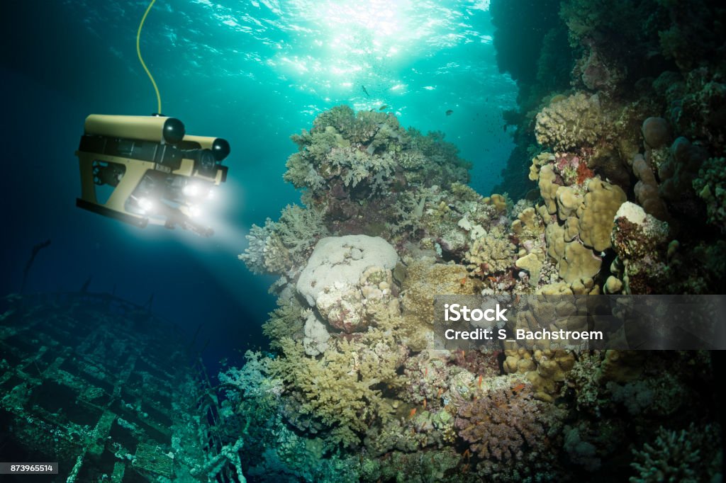 Robot inspects a sunken ship deep under water Sea Stock Photo