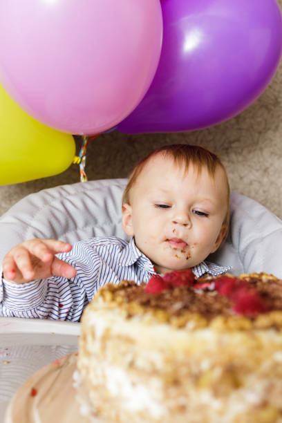 istock One year old boy celebrating his first Birthday 873972444
