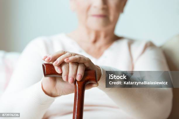 Elder Holds Hands On Walking Stick Stock Photo - Download Image Now - Parkinson's Disease, Retirement, Pension