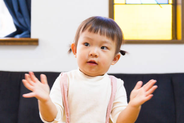 istock 1-year-old girl dancing with expressive hand movements 873978886