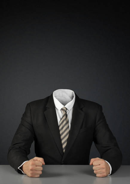 Businessman without head on dark background with copy-space