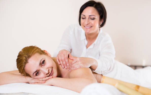 istock Young woman on massage procedure in Spa salon 873979166