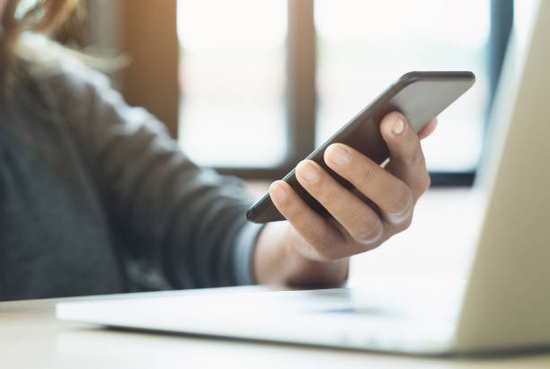 istock woman use phone on desk in office place 873988238