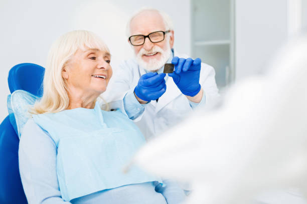 istock Positive dentist showing Xray image to the patient 873990298