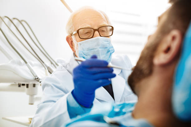 istock Close up of professional dentist with a mask 873996510