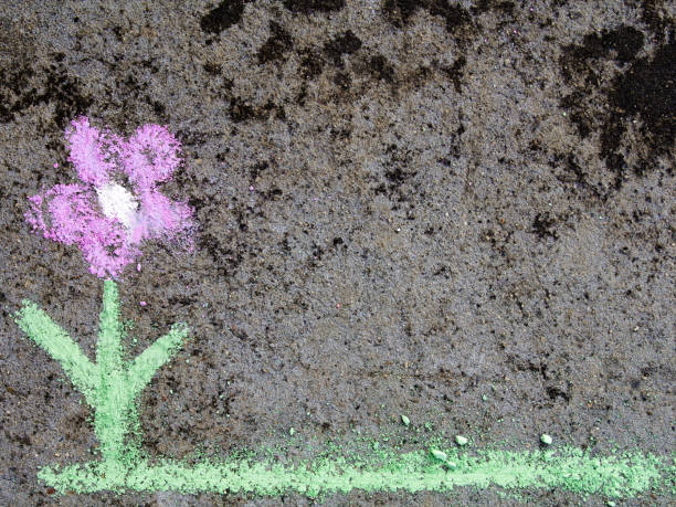 istock Colorful chalk drawing on asphalt: beautiful flower 873997260