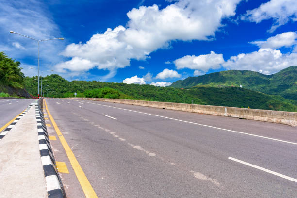 istock Asphalt road and mountains landscape under morning sky with clouds 873997404