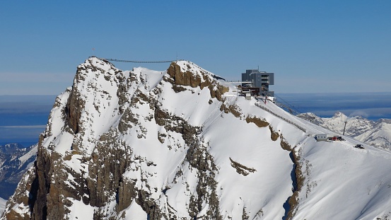 Travel destination in the Swiss Alps. Summit station of the Diablerets glacier cable car. Suspension bridge.