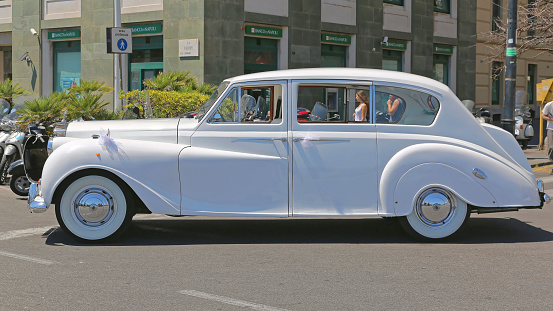 NAPLES, ITALY - JUNE 22, 2014: White Rolls Royce Luxury Wedding Car in Napoli, Italy.