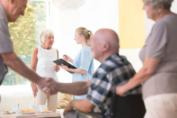 istock Senior woman talking with nurse 874001654