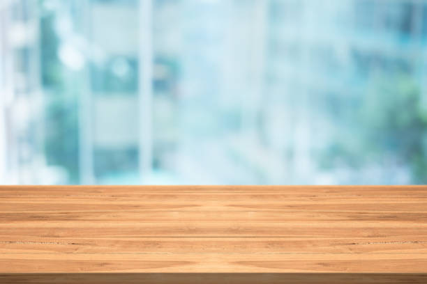 istock Empty wood table top on blurred background at office building,copyspace for montage your products 874007710
