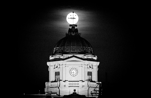 Full moon rising behind the fish weather vane on the Monroe County Courthouse.