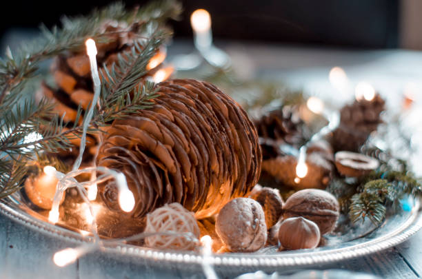istock Arrangement of nuts and cone on plate, christmas decoration 874016410
