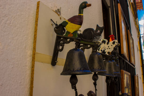 Metal doorbell. Various metal door bells in a small store in the city of Ronda. Province of Malaga, Andalusia, Spain. Photo taken – 13 n ovember 2017.