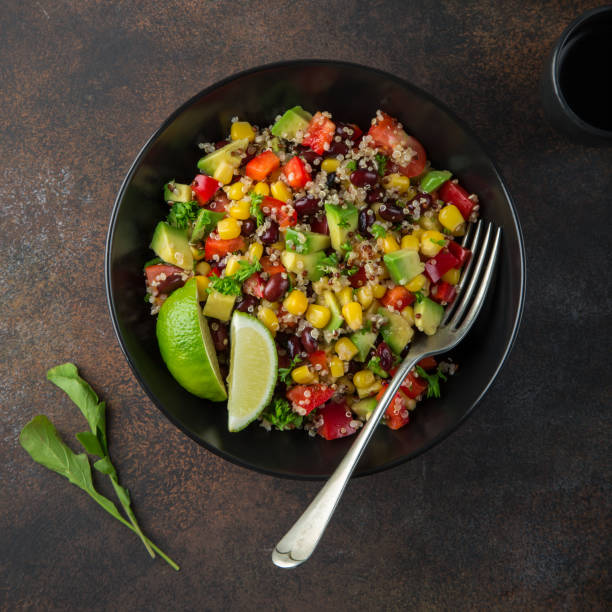 istock Avocado, quinoa, bean, corn and bell pepper salad 874029596