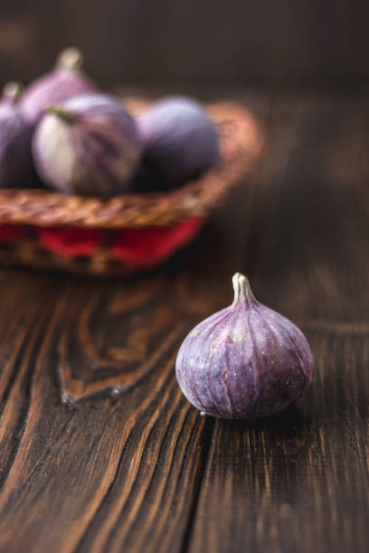 istock Fresh and ripe fig standing on the wooden table. 874031966