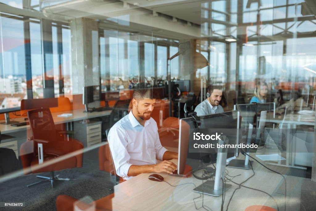 Putting in some overtime Shot of a man working in an office IT Support Stock Photo