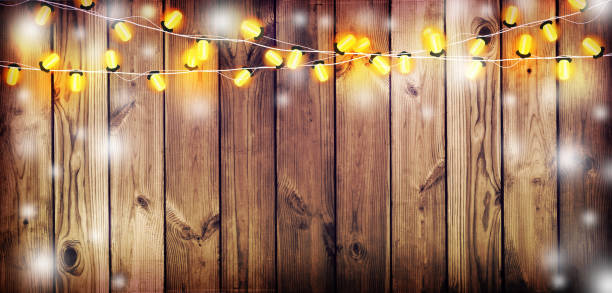 ilustrações de stock, clip art, desenhos animados e ícones de holiday lights on the old wooden background. - light bulb replace lighting equipment changing form
