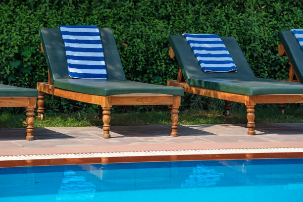 istock Deck chairs near the swimming pool 874042656