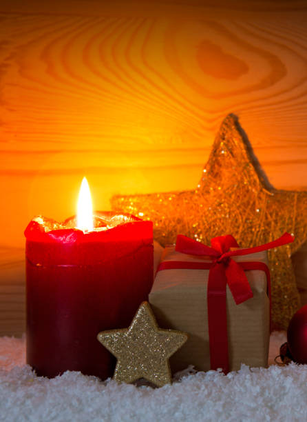istock Christmas gift box and red Advent candle. Christmas card 874045522