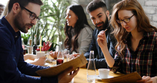 istock Group of young coworkers socializing in restaurant 874046176