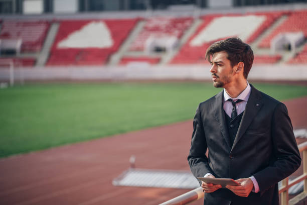 istock Businessman standing on stadium 874047910