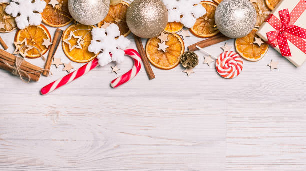 istock Christmas frame made from oranges. cinnamon, candies, various festive decor. copy space, free space for your text. close up 874054712