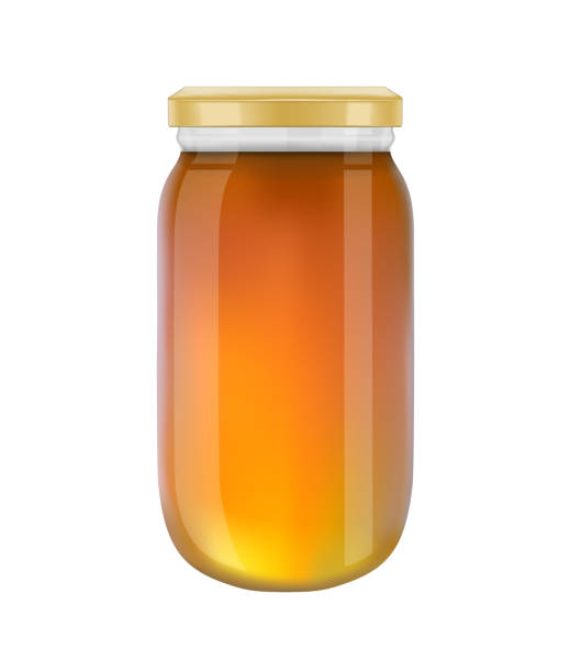 istock Glass jar of honey isolated on white background 874054798
