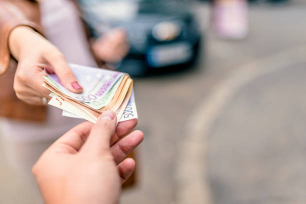 istock Paying - hand giving euro banknotes to another hand. 874055888