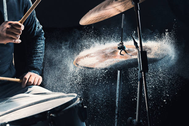 Drummer rehearsing on drums before rock concert. Man recording music on drum set in studio The hands of drummer rehearsing on drums before rock concert. Man recording music on drum set in studio with show effect in the form of flour percussion instrument stock pictures, royalty-free photos & images
