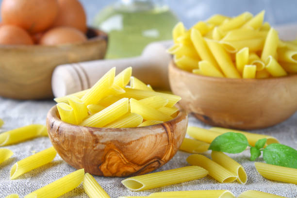 istock Penne rigate. Macaroni in the form of feathers. mostaccioli pasta. 874059444
