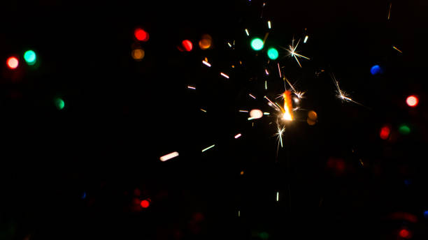 istock Sparkler and Christmas lights 874063752