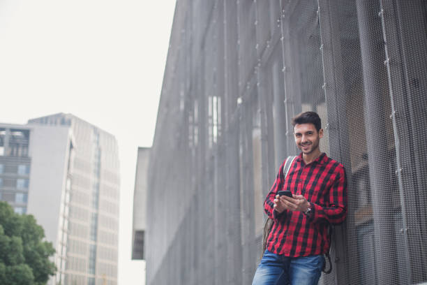 istock Young hipster man typing message on smartphone 874063776