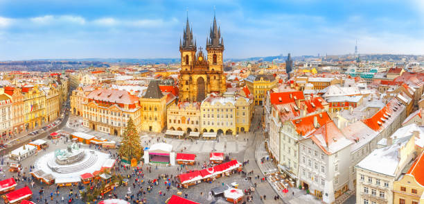 istock Prague in Christmas time. Winter snowy scenery. Classical panoramic view on old Town Square and Tyn church with Christmas fair market in Prague , Czech Republic. New Year festive time. 874067834