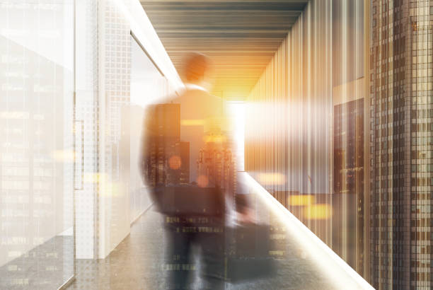 istock White and wooden office corridor, man 874068074