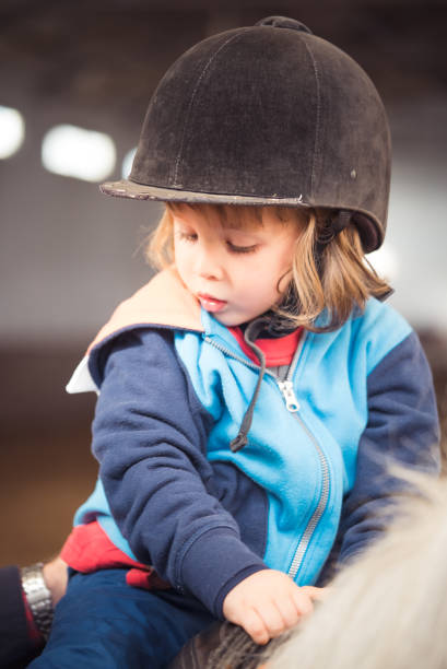 istock The Kid Riding A Horse 874071044