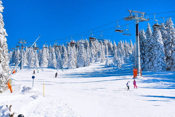 istock Ski resort, ski lift, slope, people skiing 874072502