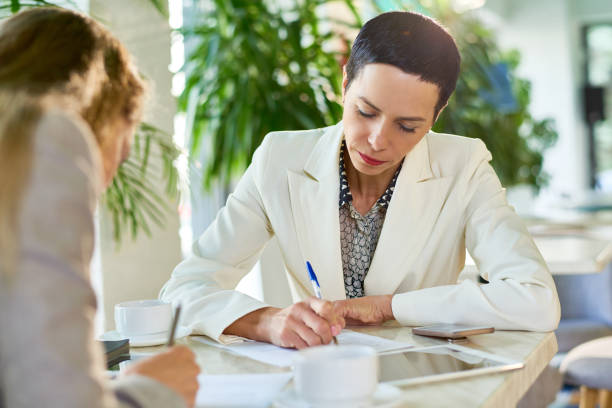 istock Female Business Leader Signing Papers 874078718