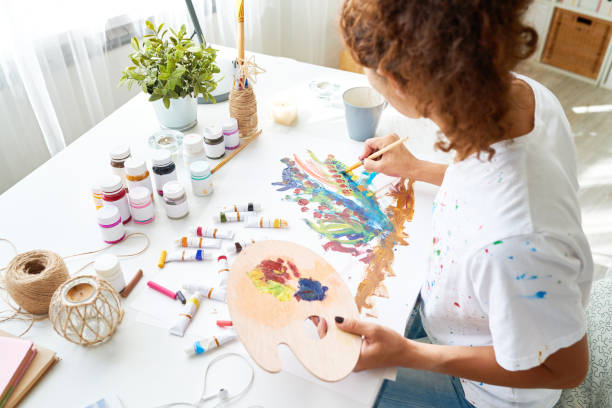 istock Creative Young Woman Painting Pictures 874083980