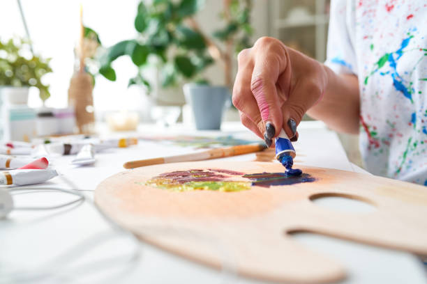 istock Artist Mixing Colors Closeup 874083984