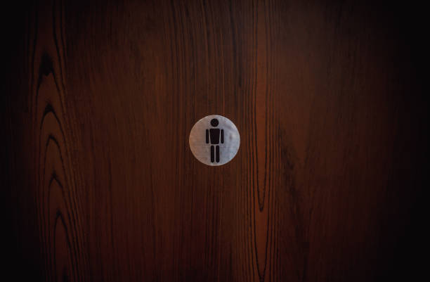 istock Man Symbol on Wooden Door 874084050