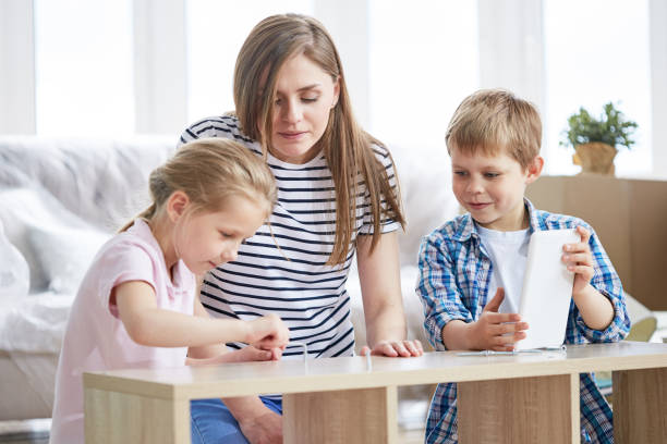 istock Assembling Furniture with Little Assistants 874084608