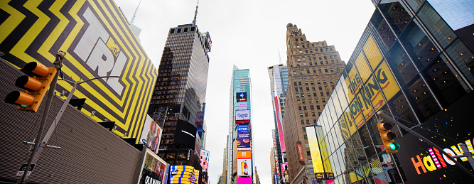 New York City Manhattan Midtown Times Square Low angle view panorama with Led billboards and building top advertisement.