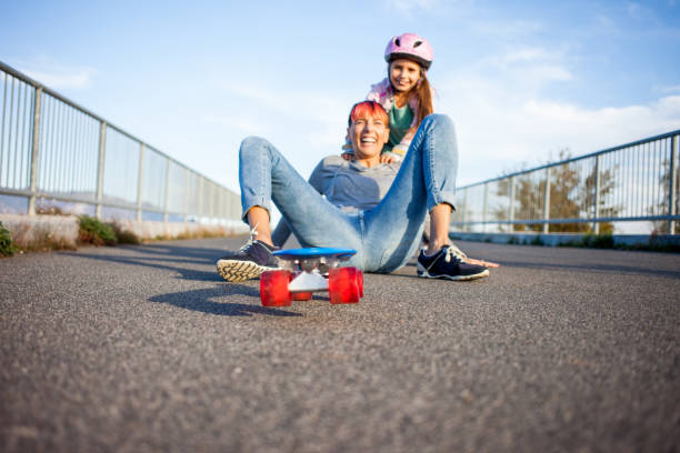 istock Mother and Daughter Playing with Skateboard 874092514