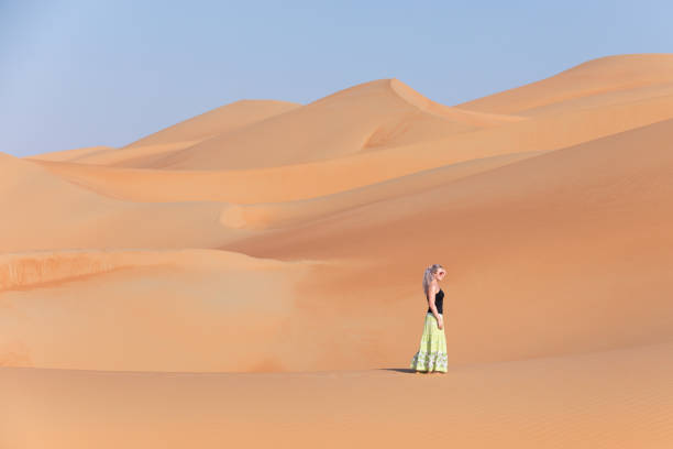 istock Young woman walking around desert. 874096302