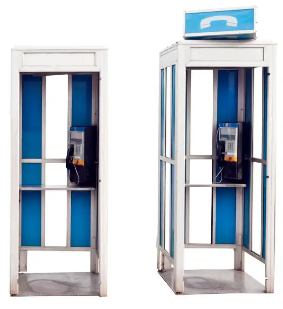 Two isolated blue and white vintage outdoor telephone booths.
