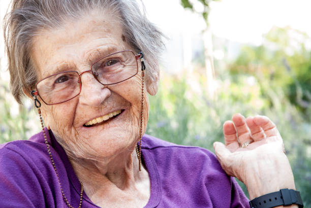 istock Smiling Senior Woman Relaxing Outdoors Portrait 874102204