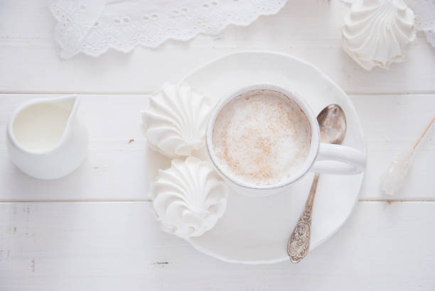 istock Coffee and marshmallow on a white wooden background 874102488