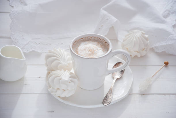 istock Coffee and marshmallow on a white wooden background 874102738