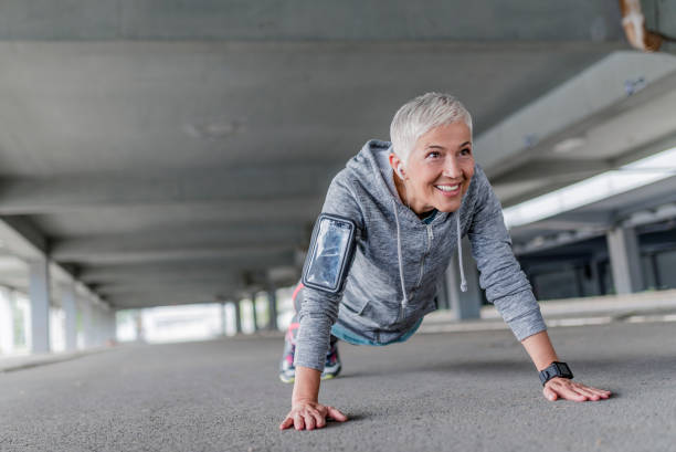 istock Fitness woman doing push-ups during outdoor cross training workout 874103254